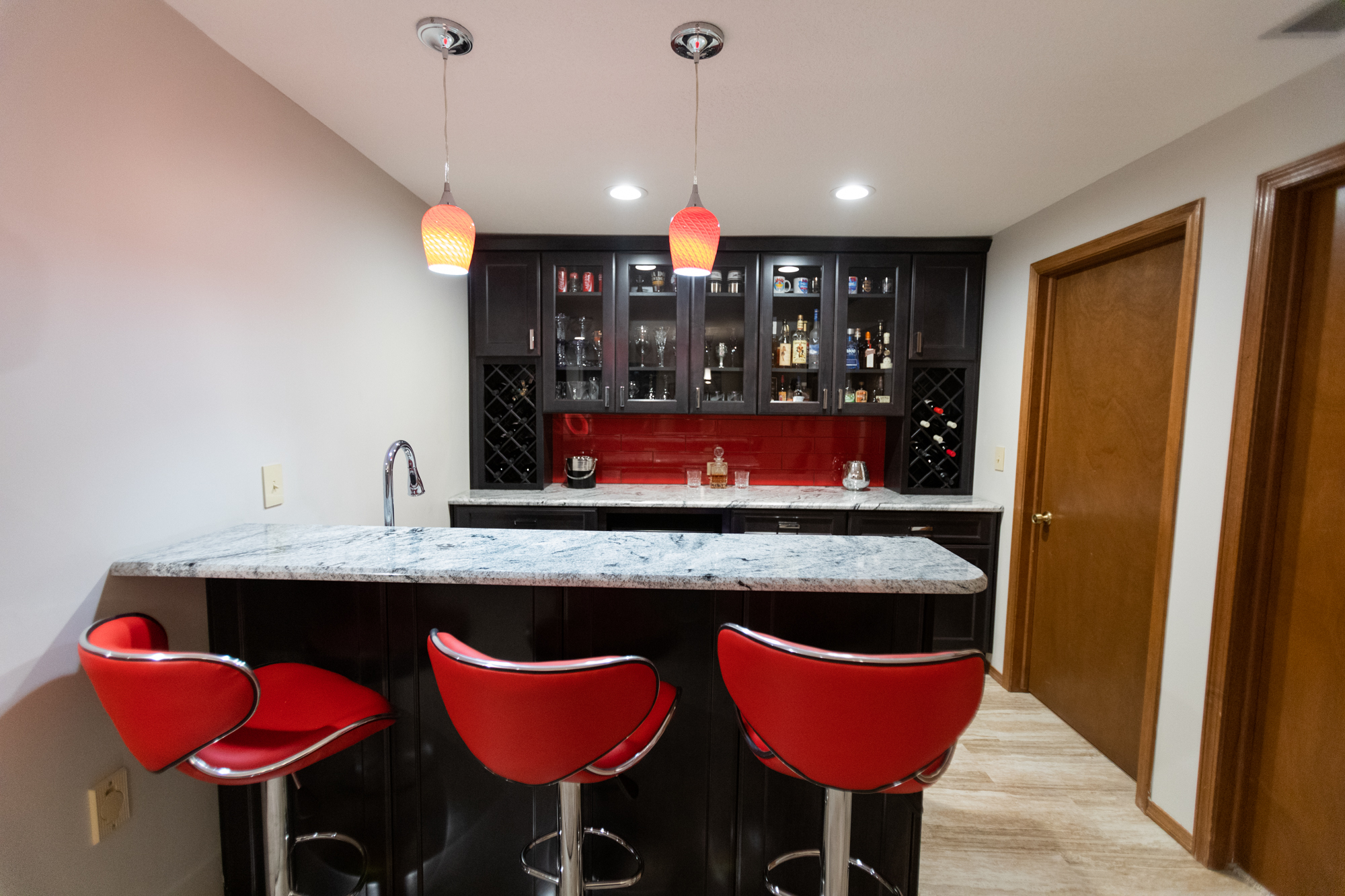 basement bar area with custom cabinetry